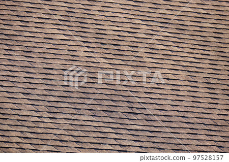 Closeup of house roof top covered with asphalt or bitumen shingles. Waterproofing of new building 97528157