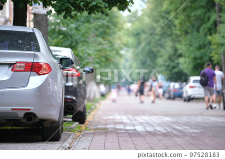 Close up of a car parked illegally against traffic rules on pedestrian city street side 97528183