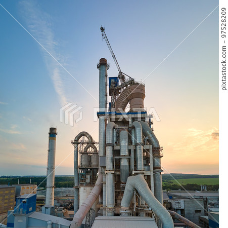 Cement plant with high factory structure and tower cranes at industrial production area. Manufacture and global industry concept 97528209