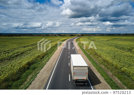 Cargo truck driving on highway hauling goods. Delivery transportation and logistics concept 97528213