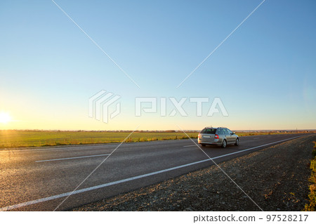 Car driving fast on intercity road at sunset. Highway traffic in evening 97528217