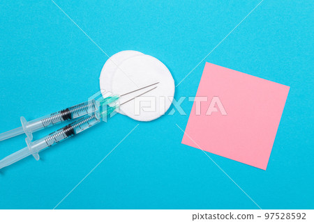 Vaccination or Revaccination Concept - Two Medical Syringe on Blue Table 97528592
