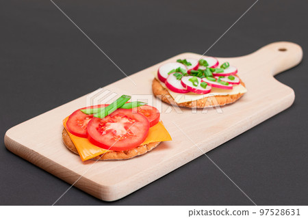 Different Cracker Sandwiches with Tomato, Cucumber, Radish and Cheese Different Cracker Sandwiches with Tomato, Cucumber, Radish and Cheese 97528631