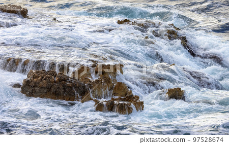 Rocky coast with waves on Mediterranean Sea. Nature Background. 97528674