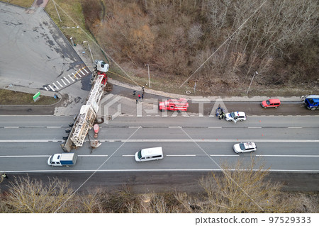 Aerial view of road accident with overturned truck blocking traffic Aerial view of road accident with overturned truck blocking traffic 97529333