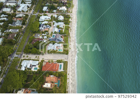 Aerial view of rich neighborhood with expensive vacation homes in Boca Grande, small town on Gasparilla Island in southwest Florida. American dream homes as example of real estate development in US Aerial view of rich neighborhood with expensive vacation homes in Boca Grande, small town on Gasparilla Island in southwest Florida. American dream homes as example of real estate development in US 97529342