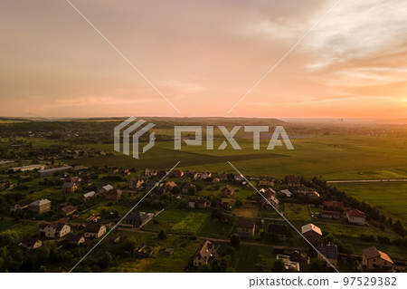 Aerial view of residential houses in suburban rural area at sunset 97529382