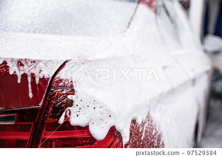 red car covered with white active foam 97529384