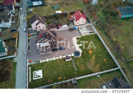 Aerial view of residential house with backyard in suburban rural area 97529407
