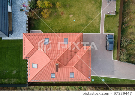 Aerial view of private house with ceramic shingles covered roof top. Investment in real estate concept 97529447