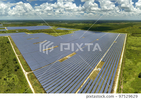 Aerial view of large sustainable electrical power plant with rows of solar photovoltaic panels for producing clean electric energy. Concept of renewable electricity with zero emission 97529629