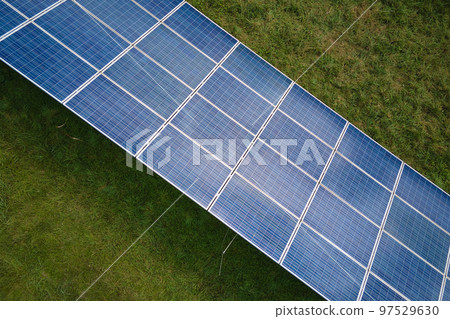 Aerial view of large sustainable electrical power plant with rows of solar photovoltaic panels for producing clean electric energy. Concept of renewable electricity with zero emission 97529630
