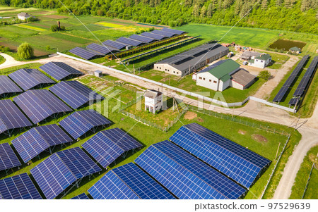 Aerial view of large sustainable electrical power plant with rows of solar photovoltaic panels for producing clean ecological electric energy. Renewable electricity with zero emission concept. 97529639