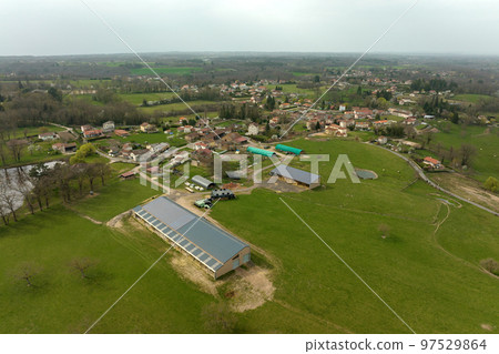 Aerial view of farm building with photovoltaic solar panels mounted on rooftop for producing clean ecological electricity. Production of renewable energy concept 97529864