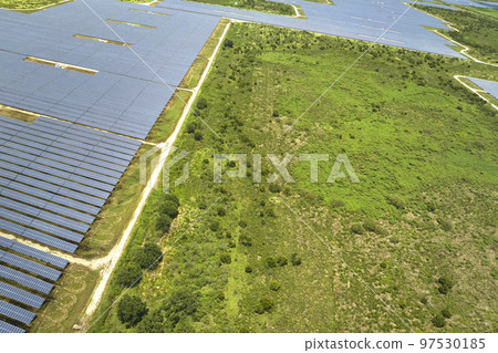 Aerial view of big sustainable electric power plant with many rows of solar photovoltaic panels for producing clean electrical energy. Renewable electricity with zero emission concept 97530185