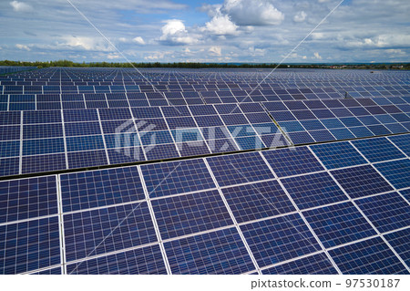 Aerial view of big sustainable electric power plant with many rows of solar photovoltaic panels for producing clean electrical energy. Renewable electricity with zero emission concept Aerial view of big sustainable electric power plant with many rows of solar photovoltaic panels for producing clean electrical energy. Renewable electricity with zero emission concept 97530187