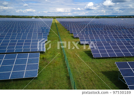 Aerial view of big sustainable electric power plant with many rows of solar photovoltaic panels for producing clean electrical energy. Renewable electricity with zero emission concept 97530189
