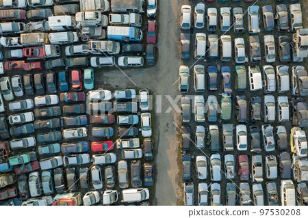 Aerial view of big parking lot of junkyard with rows of discarded broken cars. Recycling of old vehicles 97530208