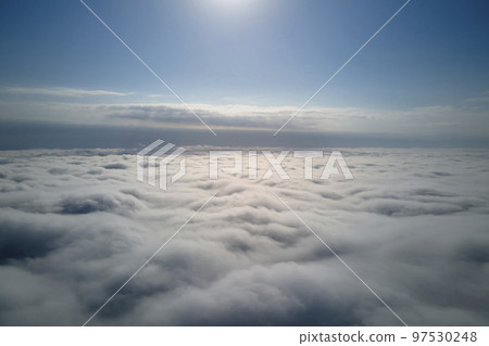 Aerial view from high altitude of earth covered with puffy rainy clouds forming before rainstorm Aerial view from high altitude of earth covered with puffy rainy clouds forming before rainstorm 97530248