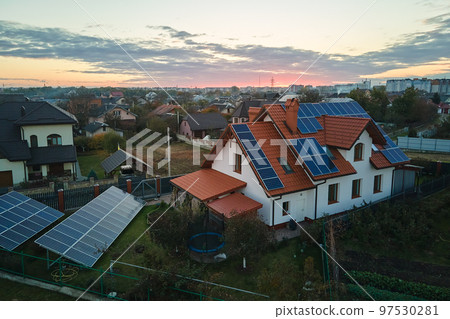 Aerial view building roof with rows of blue solar photovoltaic panels for producing clean ecological electric energy. Renewable electricity with zero emission concept Aerial view building roof with rows of blue solar photovoltaic panels for producing clean ecological electric energy. Renewable electricity with zero emission concept 97530281