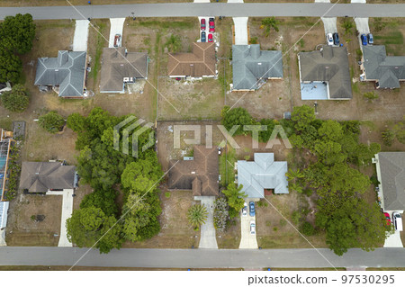 Aerial landscape view of suburban private houses between green palm trees in Florida rural area 97530295