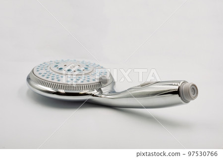New chrome shower head water spray adjustable closeup on white New chrome shower head water spray adjustable closeup on white 97530766