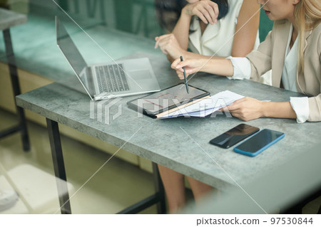 Cropped image of female entrepreneurs meeting in cafe to discuss new project 97530844