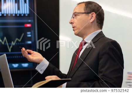 Close-up of financial analyst analyzing graphs Close-up of financial analyst analyzing graphs 97532542