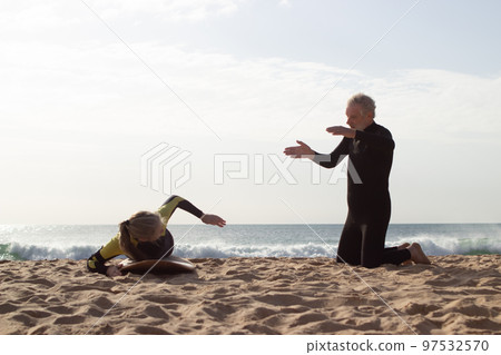 Sporty aged couple training before surfing 97532570