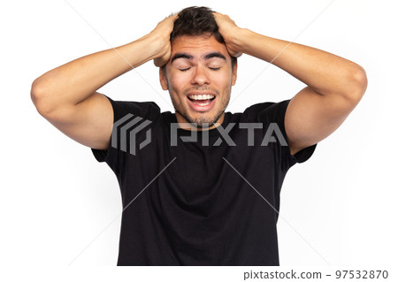Amazed young man with hands on head 97532870