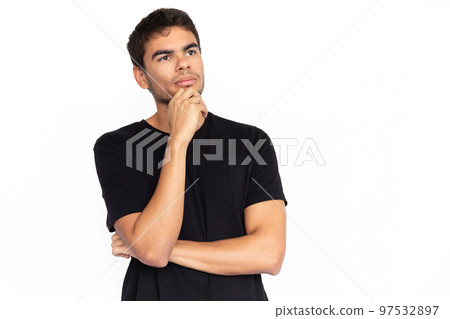 Pensive young man leaning on hand Pensive young man leaning on hand 97532897