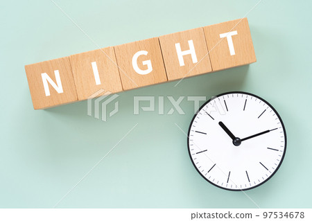 A block and a clock written as NIGHT 97534678