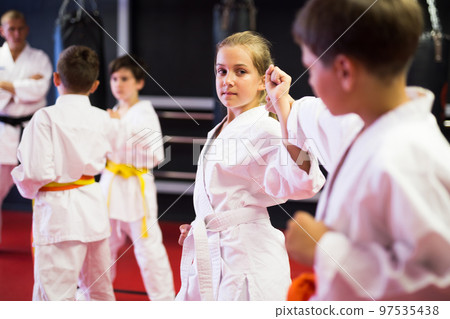 Boys and girls in kimono sparring together 97535438