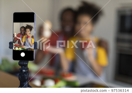 Family Blog. Black Father And Preteen Daughter Capturing Video In Kitchen Family Blog. Black Father And Preteen Daughter Capturing Video In Kitchen 97536314