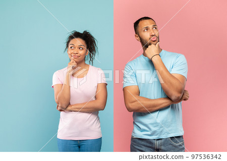 Portrait of thoughtful black man and woman thinking and looking away, touching chin, dreaming or making decision 97536342