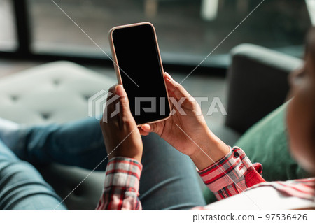 Millennial black lady use smartphone with empty screen, recommend app and website, chatting at spare time Millennial black lady use smartphone with empty screen, recommend app and website, chatting at spare time 97536426