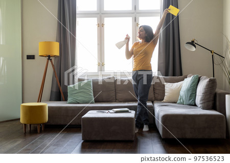 Happy Young Arab Woman Having Fun While Cleaning At Home Happy Young Arab Woman Having Fun While Cleaning At Home 97536523