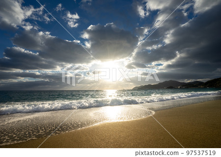 beach and waves at sunset 97537519