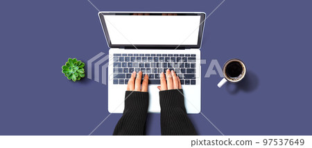 Person using a laptop computer 97537649