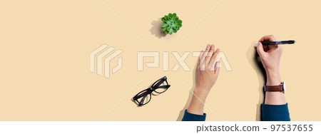 Person writing something with a pen 97537655