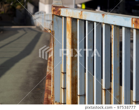 Railing of a rusty pedestrian bridge 97538777