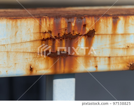 Railing of a rusty pedestrian bridge 97538825