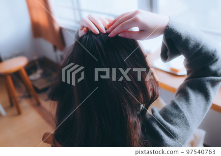 Photo of a young woman eating breakfast in her room 97540763