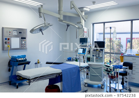 Medical equipment, technology and lighting over operating table in empty hospital operating theatre Medical equipment, technology and lighting over operating table in empty hospital operating theatre 97542238