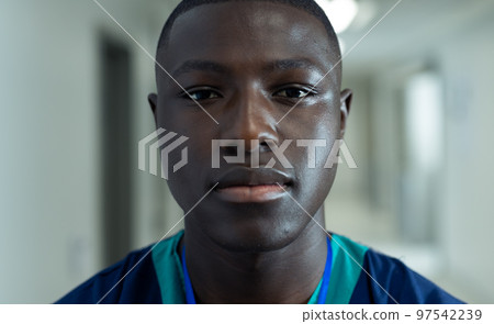 Portrait of african american male healthcare worker in hospital corridor, copy space 97542239
