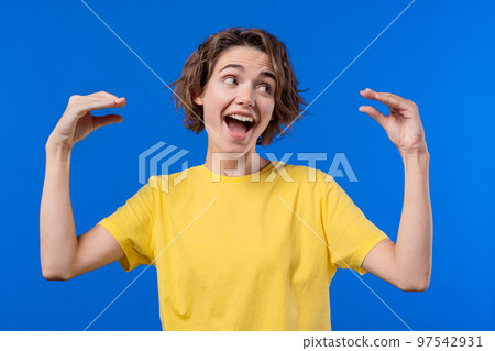 Funny woman showing bla-bla-bla gesture with hands on blue background. Empty promises, irony, blah Funny woman showing bla-bla-bla gesture with hands on blue background. Empty promises, irony, blah 97542931
