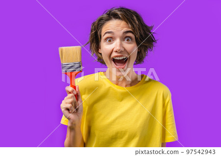 Happy woman artist with painting brush on violet background. Creative person, fantasy, idea, non 97542943