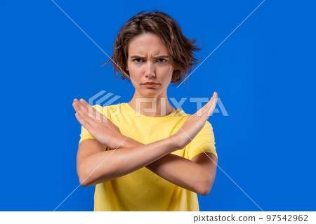 Uninterested woman disapproving with NO crossing hands sign gesture. Denying, rejecting, disagree 97542962