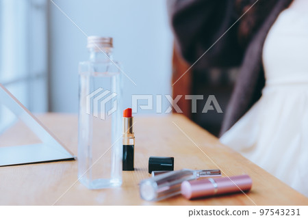 Photo of young woman doing morning makeup 97543231