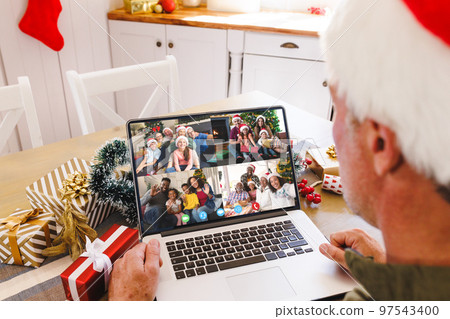 Senior caucasian man having christmas video call with diverse people Senior caucasian man having christmas video call with diverse people 97543400